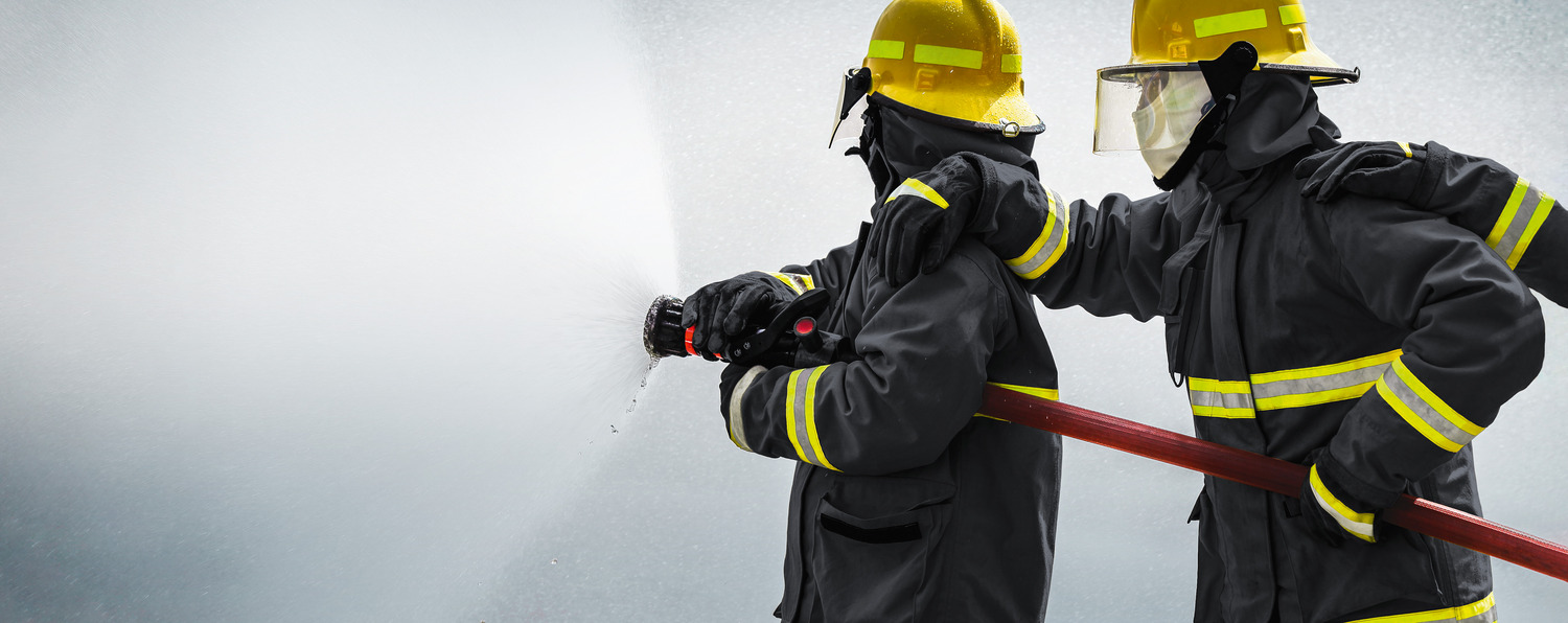 Firefighter at work - wearing fireresistant clothes made from high performance fibers