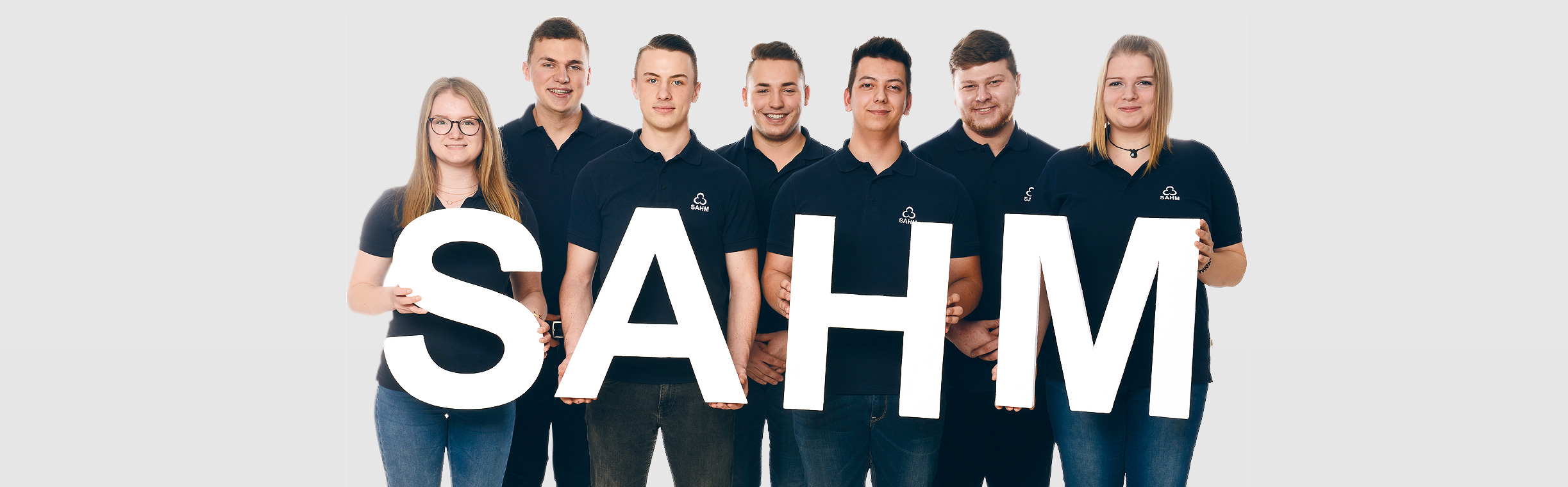 SAHM trainees Seven SAHM trainees holding the four letters "SAHM" in front of them